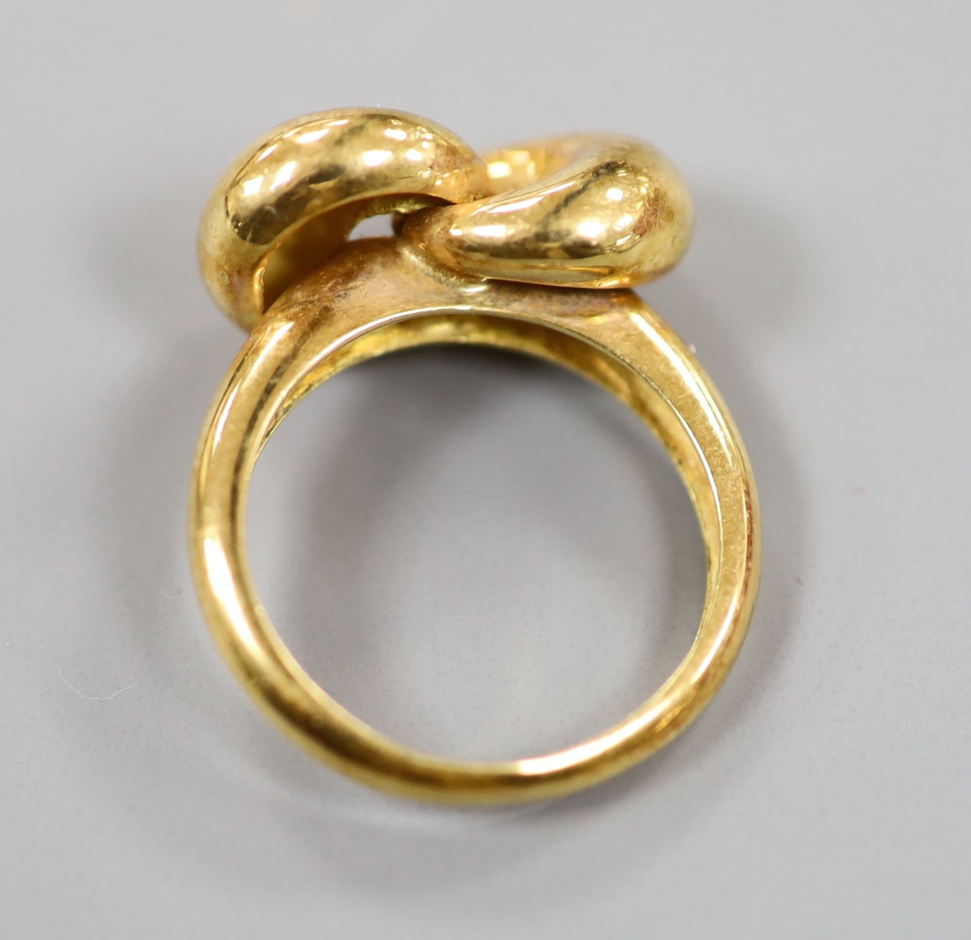 A 750 yellow metal 'knot' ring, size L, 6.4 grams.